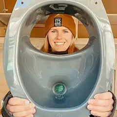 Woman holding composting toilet insert