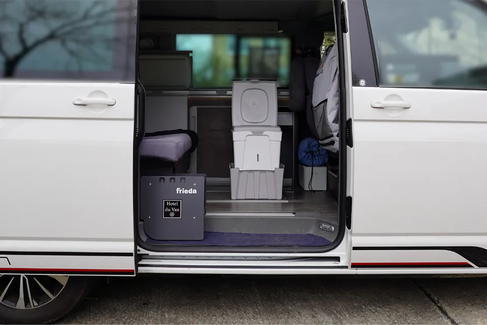Portable camping toilet in van